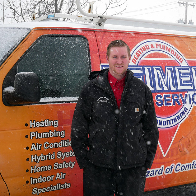 A Reimer HVAC technician poses in front of his vehicle before heading out to make Buffalo heater repairs.