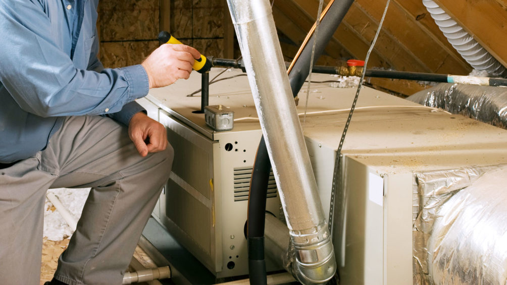 Our technician works on this gas furnace, located in this home's attic, to ensure that it's running right.