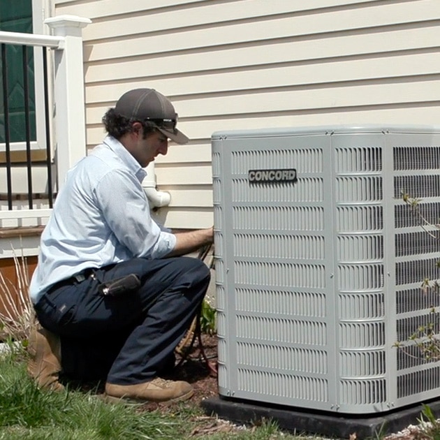 A Reimer HVAC contractor in Buffalo, NY inspects this home's air conditioner, diagnosing any potential issues.