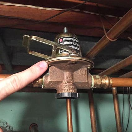 Our plumber finishes installing a new water pressure reduction valve in a local North Tonawanda home.