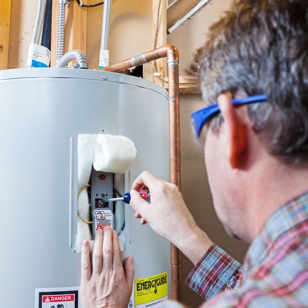 One of our plumbers uses a flathead screwdriver to fix this water heater here in Buffalo, NY.